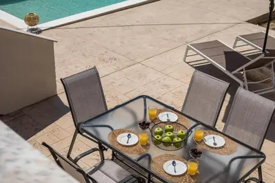 a table with a bowl of fruit on it at Anastasia Luxury House in Afantou