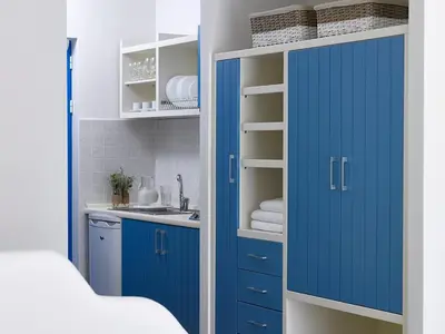 a kitchen with blue cabinets and a sink at Lindia Thalassa in Pefki Rhodes