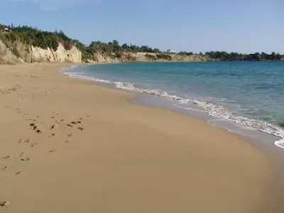 a beach with footprints in the sand and the water at Lindia Thalassa in Pefki Rhodes