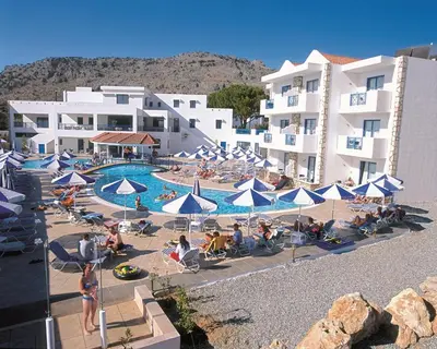 a group of people sitting around a pool at a hotel at Lindia Thalassa in Pefki Rhodes