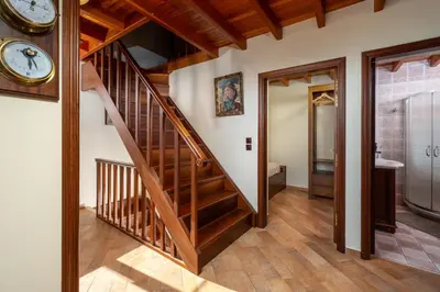 a staircase in a house with a clock on the wall at Suite del Capitano in Rhodes Town