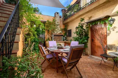 an outdoor patio with a table and chairs at Suite del Capitano in Rhodes Town