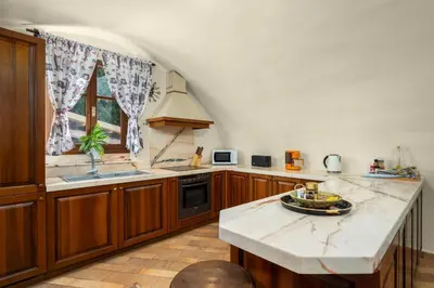 a kitchen with wooden cabinets and a white counter top at Suite del Capitano in Rhodes Town