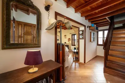 a hallway with a table with a lamp and a mirror at Suite del Capitano in Rhodes Town