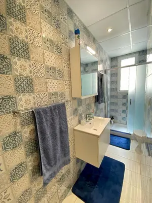 a bathroom with a sink and a mirror at Cozy blue in Ialyssos