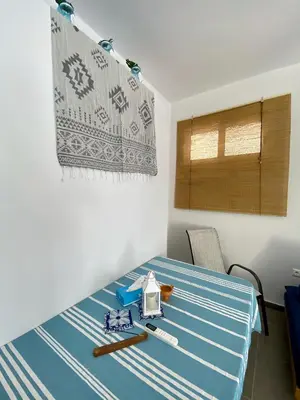 a dining room table with a blue and white table cloth at Cozy blue in Ialyssos