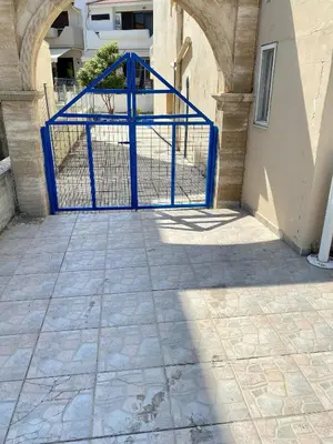 a blue gate in front of a building at Cozy blue in Ialyssos