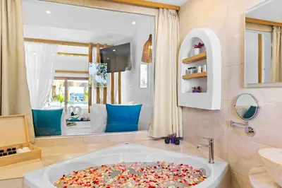 a sink in a bathroom with a large mirror at Alia Beachfront Suites and Spa in Haraki