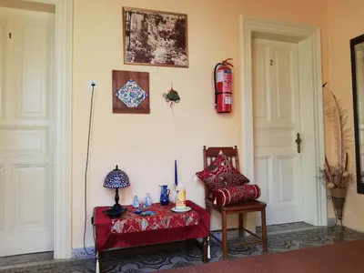 a living room with a red chair and a table at Hotel Anastasia in Rhodes Town