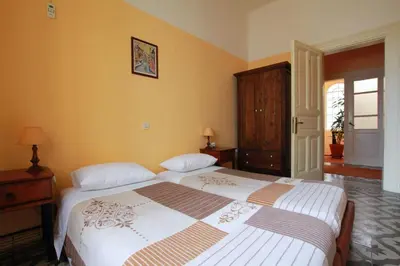 a bedroom with two beds and a dresser at Hotel Anastasia in Rhodes Town