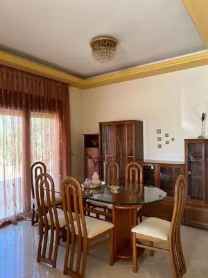 a dining room with a wooden table and chairs at Luna's Summer House in Kremasti