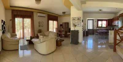 a large living room with two chairs and a table at Luna's Summer House in Kremasti