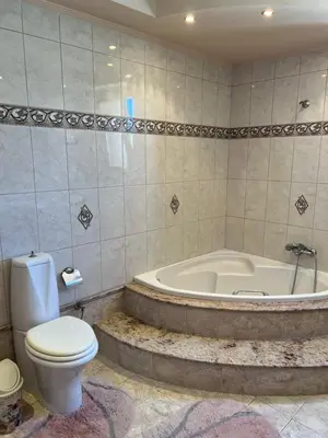 a bathroom with a bath tub and a toilet and a bath tub at Luna's Summer House in Kremasti