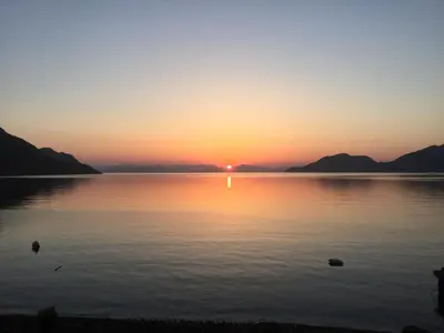 a sunset over a large body of water at Nikolitsi Studios in Symi