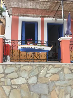 a balcony of a house with a sign on it at Nikolitsi Studios in Symi