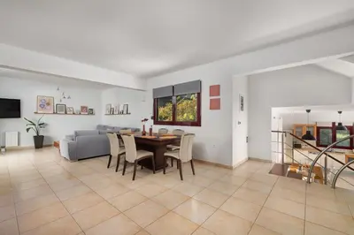 a living room with a table and a couch at Cicada Villa in Koskinou