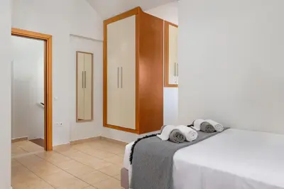 a bedroom with a bed with towels on it at Cicada Villa in Koskinou