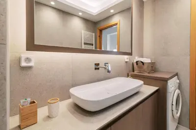 a bathroom with a white sink and a mirror at Cicada Villa in Koskinou