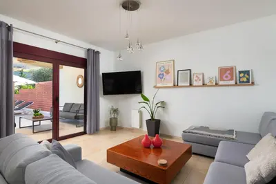 a living room with a couch and a table at Cicada Villa in Koskinou