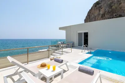 a villa with a swimming pool on a balcony at Hamilton Sea Front Villa in Archangelos