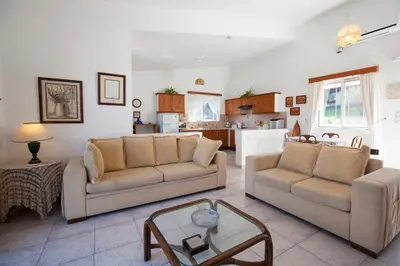a living room with two couches and a table at The Olive Grove Villa Private Pool with Sea & Sunset Views in Theologos