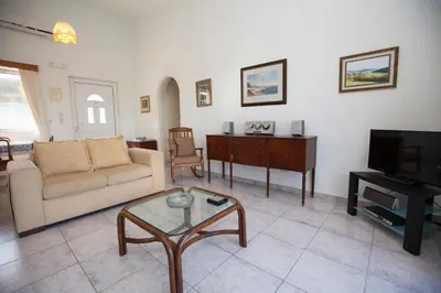 a living room with a couch and a table at The Olive Grove Villa Private Pool with Sea & Sunset Views in Theologos