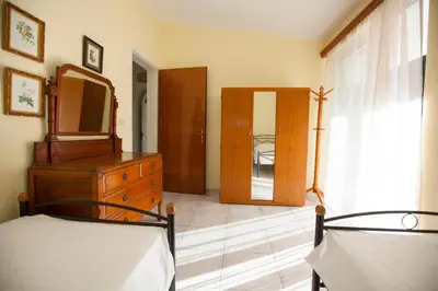a bedroom with a dresser and a mirror and a bed at The Olive Grove Villa Private Pool with Sea & Sunset Views in Theologos