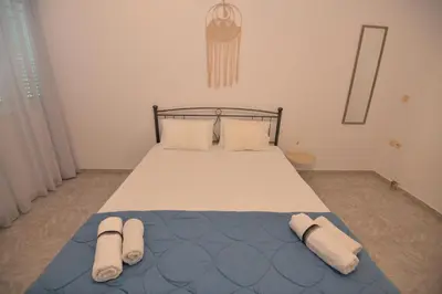 a bedroom with a bed with two towels on it at Nina's Apt in Ialysos near the Beach in Ialyssos