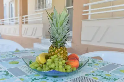 a bowl of fruit sitting on a table at Nina's Apt in Ialysos near the Beach in Ialyssos