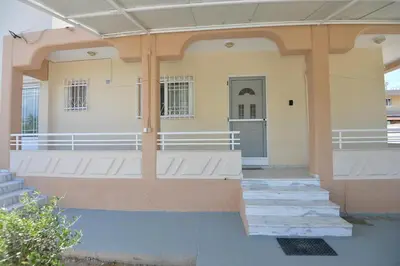 a front porch of a house with stairs and a door at Nina's Apt in Ialysos near the Beach in Ialyssos