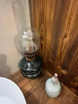 a glass jar sitting on top of a wooden table at The Priest's Traditional House Kalithies in Kalithies