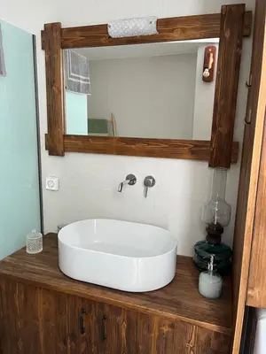 a bathroom with a sink and a mirror at The Priest's Traditional House Kalithies in Kalithies