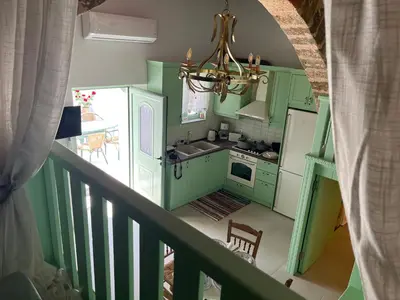 an overhead view of a kitchen with green cabinets at The Priest's Traditional House Kalithies in Kalithies
