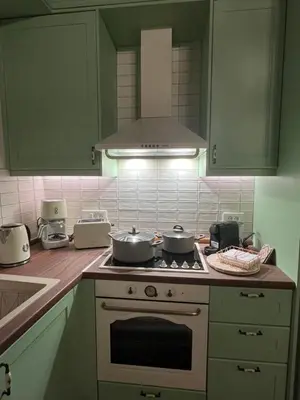 a kitchen with two pots and pans on a stove at The Priest's Traditional House Kalithies in Kalithies