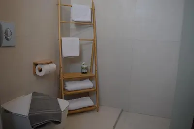 a bathroom with a towel rack and a toilet at The Priest's Traditional House Kalithies in Kalithies