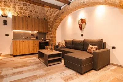 a living room with a couch and a table at Inverno Medieval apartment in Rhodes Town