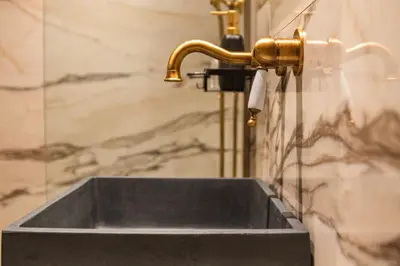 a sink in a bathroom with a gold faucet at Inverno Medieval apartment in Rhodes Town