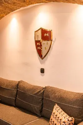 a living room with a couch and a shield on the wall at Inverno Medieval apartment in Rhodes Town