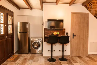 a kitchen with a refrigerator and two bar stools at Inverno Medieval apartment in Rhodes Town