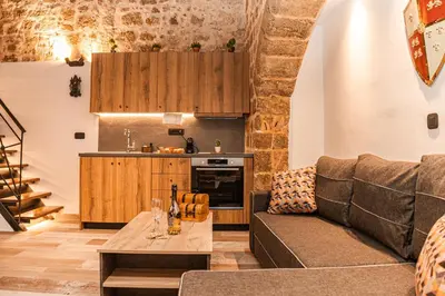 a living room with a couch and a table at Inverno Medieval apartment in Rhodes Town