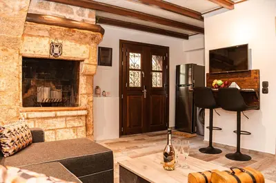 a living room with a fireplace and a television at Inverno Medieval apartment in Rhodes Town
