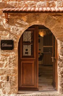 an entrance to a stone building with a wooden door at Inverno Medieval apartment in Rhodes Town
