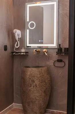 a bathroom with a large sink and a mirror at Medieval apartment Estiva in Rhodes Town