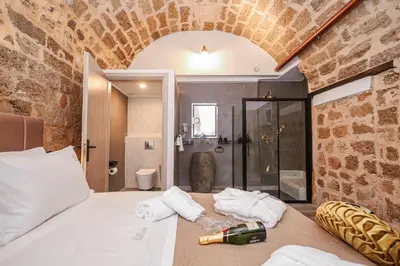 a bedroom with a bed with a bottle of wine on it at Medieval apartment Estiva in Rhodes Town