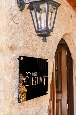 a sign on the side of a building with a lamp at Medieval apartment Estiva in Rhodes Town