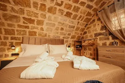 a bedroom with a bed with towels on it at Medieval apartment Estiva in Rhodes Town