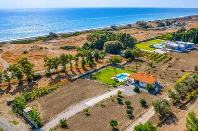 an aerial view of a house and the ocean at Kalimera Villa By the Sea in Gennadi