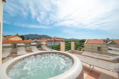 a hot tub on the balcony of a building at Villa De Ella in Ialyssos