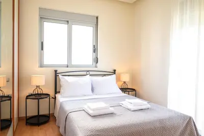 a bedroom with a bed with two towels on it at Villa De Ella in Ialyssos