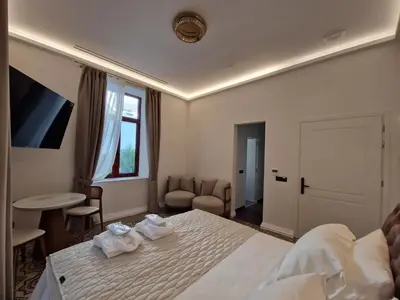 a hotel room with a bed with towels on it at Jensen Luxury Suites in Rhodes Town